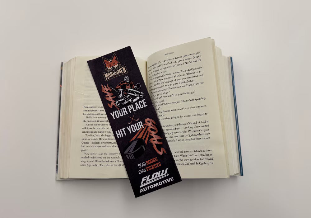 Reading achievement bookmark laying in the middle of an open book